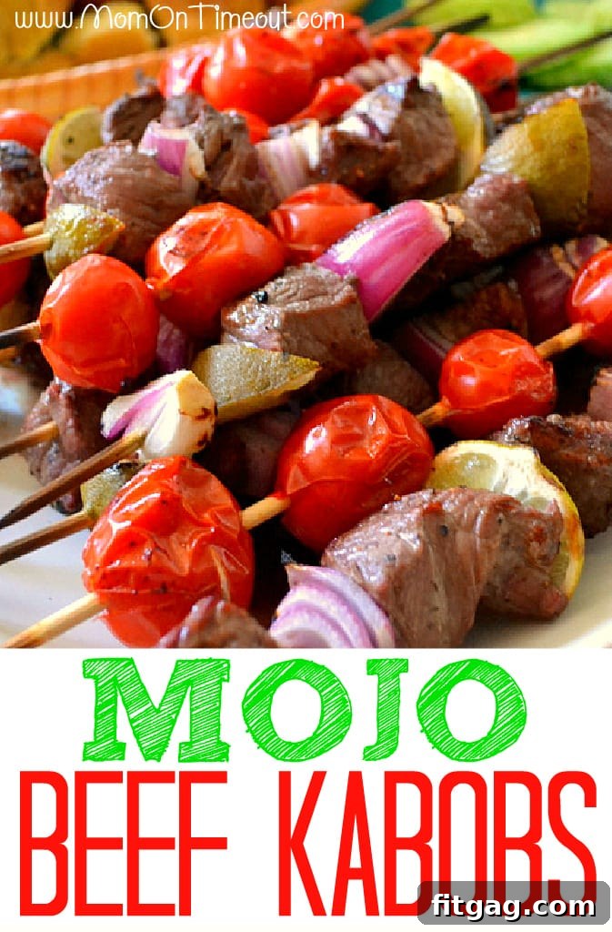 Grilled Mojo Beef Kabobs on skewers, presented on a white plate with fresh ingredients