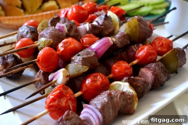 Assortment of grilled kabobs and fresh ingredients on a picnic table