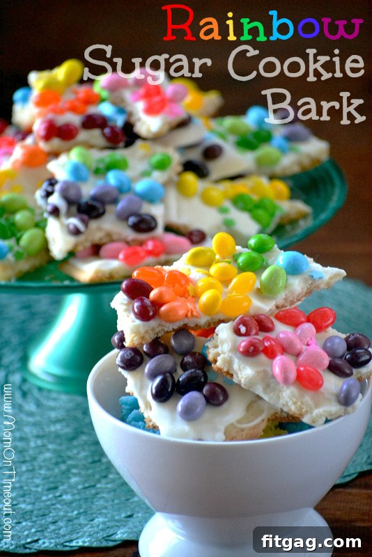Confetti Sugar Cookie Bark 2 Delicious Rainbow Sugar Cookie Bark, broken into colorful pieces in a serving bowl, showcasing layers of cookie, candy coating, and assorted candies. Perfect for St. Patrick's Day and kid-friendly parties.