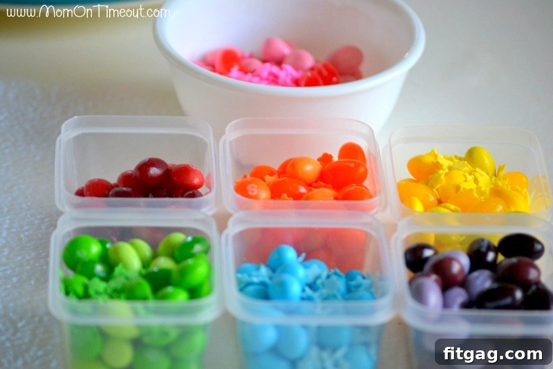 Confetti Sugar Cookie Bark 5 Individual containers filled with sorted rainbow candies, neatly organized by color, ready for the sugar cookie bark preparation. An essential step for a perfect rainbow dessert.