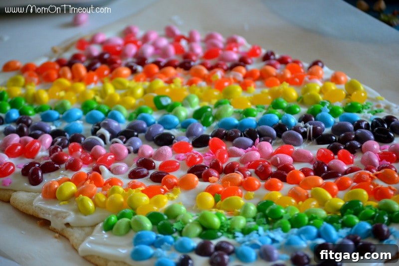 Confetti Sugar Cookie Bark 8 The fully decorated Rainbow Sugar Cookie Bark, showcasing perfectly arranged rows of colorful candies over a vanilla candy coating, prior to being broken into pieces.