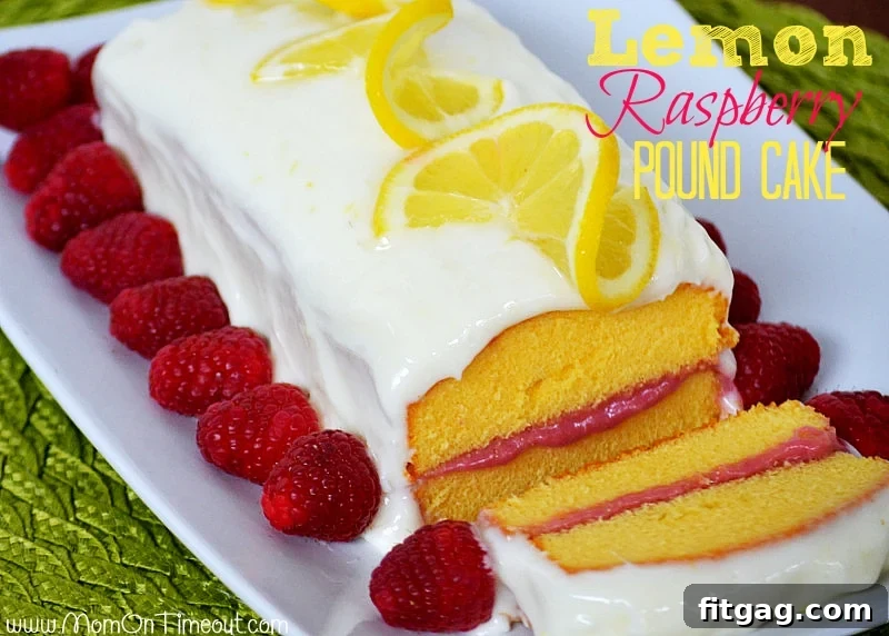 Lemon Raspberry Pound Cake | MomOnTimeout.com - Lemon Cream Cheese Frosting and a Raspberry Filling make this dessert extra special! #lemon #raspberry #recipe #dessert Lemon Raspberry Pound Cake Recipe with Cream Cheese Frosting - MomOnTimeout.com. A close-up of the beautifully garnished cake, showing fresh lemon slices and raspberries. Perfect for easy dessert ideas and entertaining. #easyrecipes #poundcakerecipe #lemonlover #raspberrydessert #hostingtips