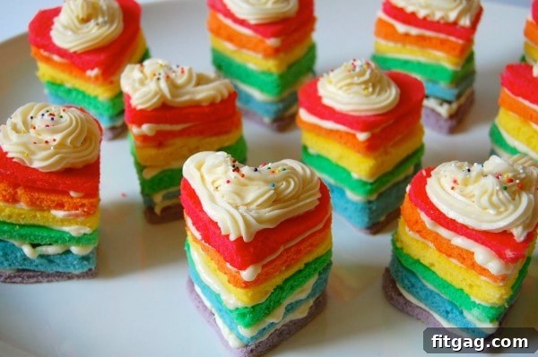 Adorable Rainbow Heart Cakes, small heart-shaped cakes with colorful layers, perfect for a romantic or festive treat.
