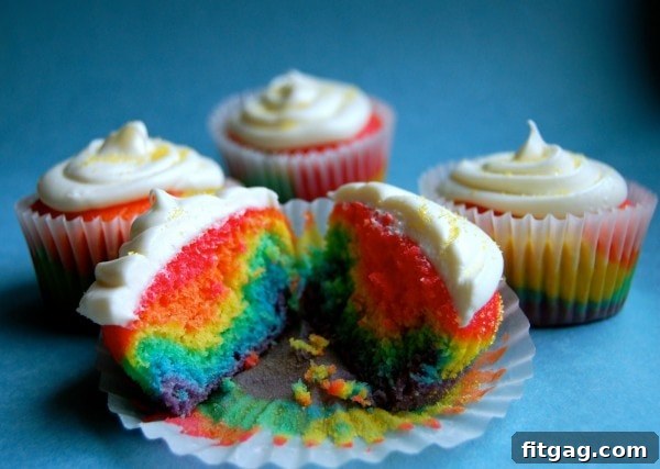 Vibrant Rainbow Cupcakes from Wine & Glue, featuring colorful swirls and festive decorations.