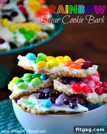 Colorful Rainbow Sugar Cookie Bark, a festive treat with layers of sugar cookie and white chocolate, adorned with sprinkles.
