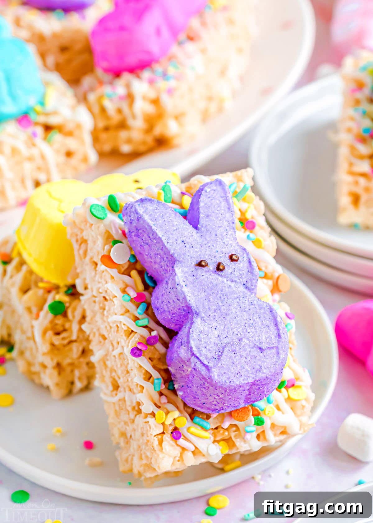 Gooey Peeps Cereal Bars 3 A close-up view of a vibrant purple Peep resting atop a perfectly crafted Rice Krispie Treat, showcasing its festive appeal.