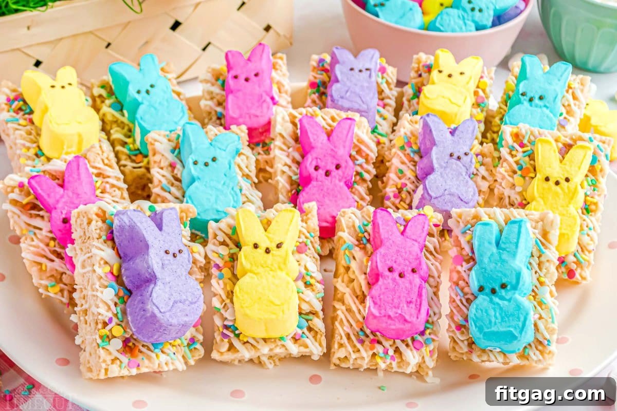Gooey Peeps Cereal Bars 4 A charming collection of Rice Krispie Treats, each adorned with sprinkles and topped with a colorful Easter Peep, elegantly arranged on a white plate, inviting guests to enjoy this festive dessert.