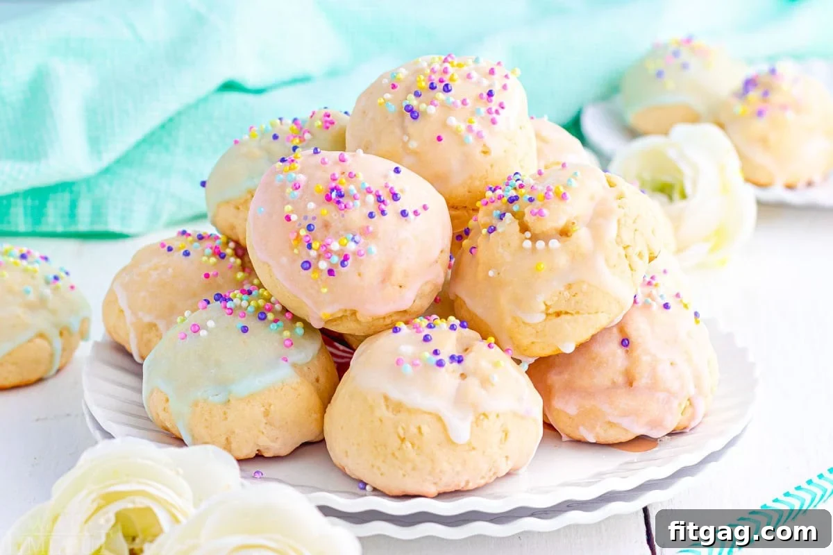 Sweet Italian Easter Cookie Delights 6 A wide shot of a white scalloped plate overflowing with vibrant, colorful Italian Easter cookies, each adorned with pastel glazes and a variety of festive sprinkles.