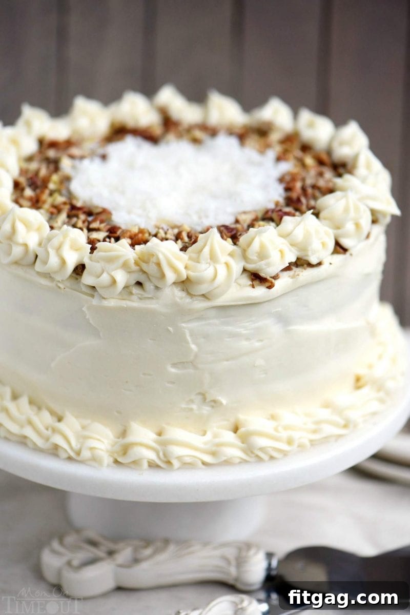 A whole carrot cake with cream cheese frosting and pineapple, ready to be served.