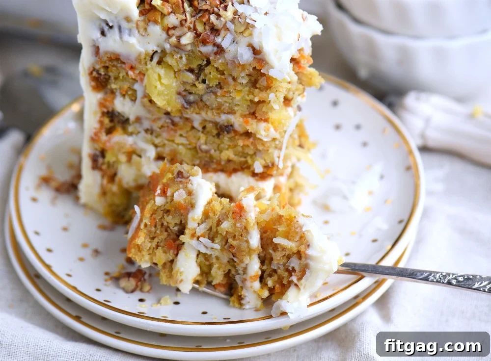 A beautifully frosted carrot cake, ready to be served, highlighting its rich cream cheese frosting.
