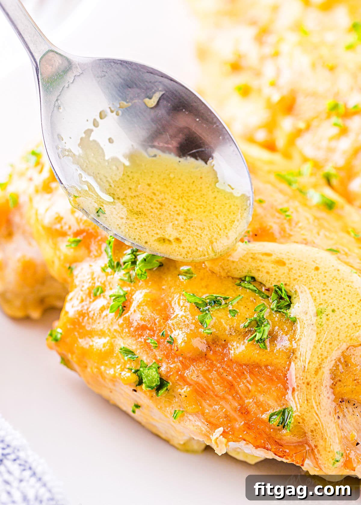 Crispy Honey Mustard Chicken Bites 3 A close-up shot of freshly baked chicken breast, glistening with a generous drizzle of homemade honey mustard sauce, ready to be served.