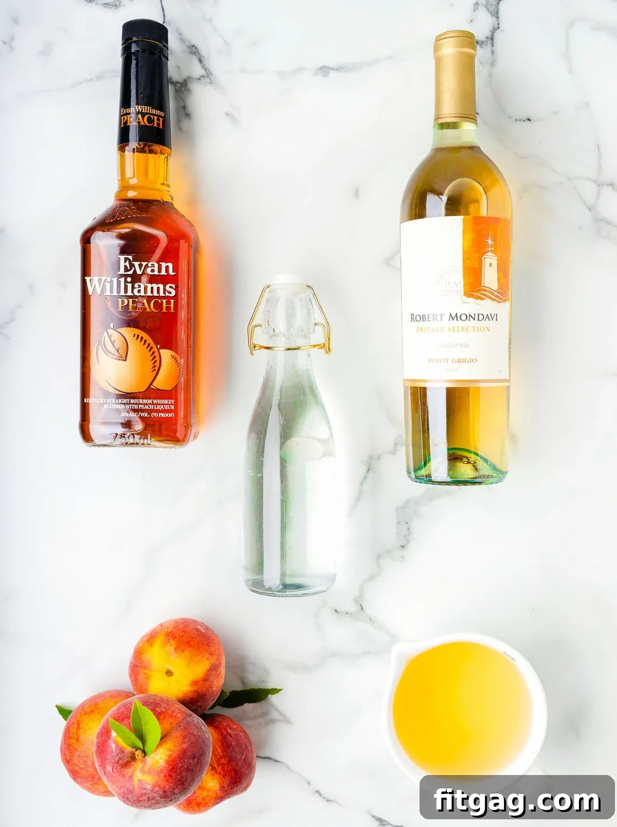 Golden Peach Sangria 4 top down look at peach sangria ingredients placed on a white marble surface.