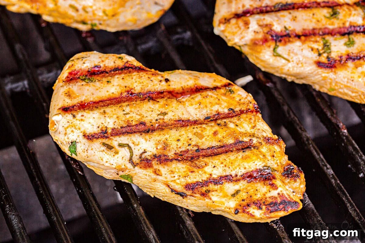 chicken breast being grilled with nice sear marks shown.