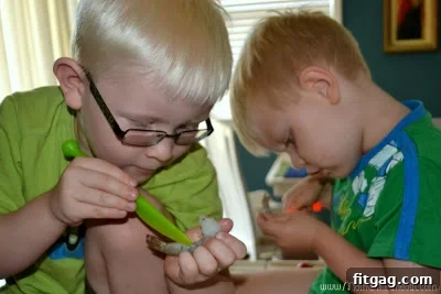 Close-up of hands deveining raw shrimp, possibly with child helpers