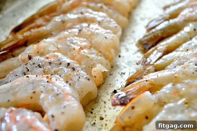 Skewered shrimp marinating in a bowl with lime wedges and olive oil