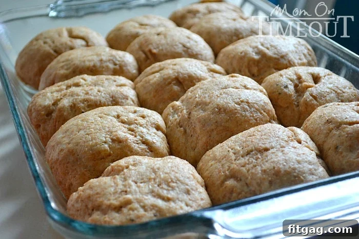 Whole wheat roll dough rising in a bowl, showcasing the perfect texture before baking. Essential step for light and fluffy homemade rolls. #wheatrolls #doughrising #bakingtips