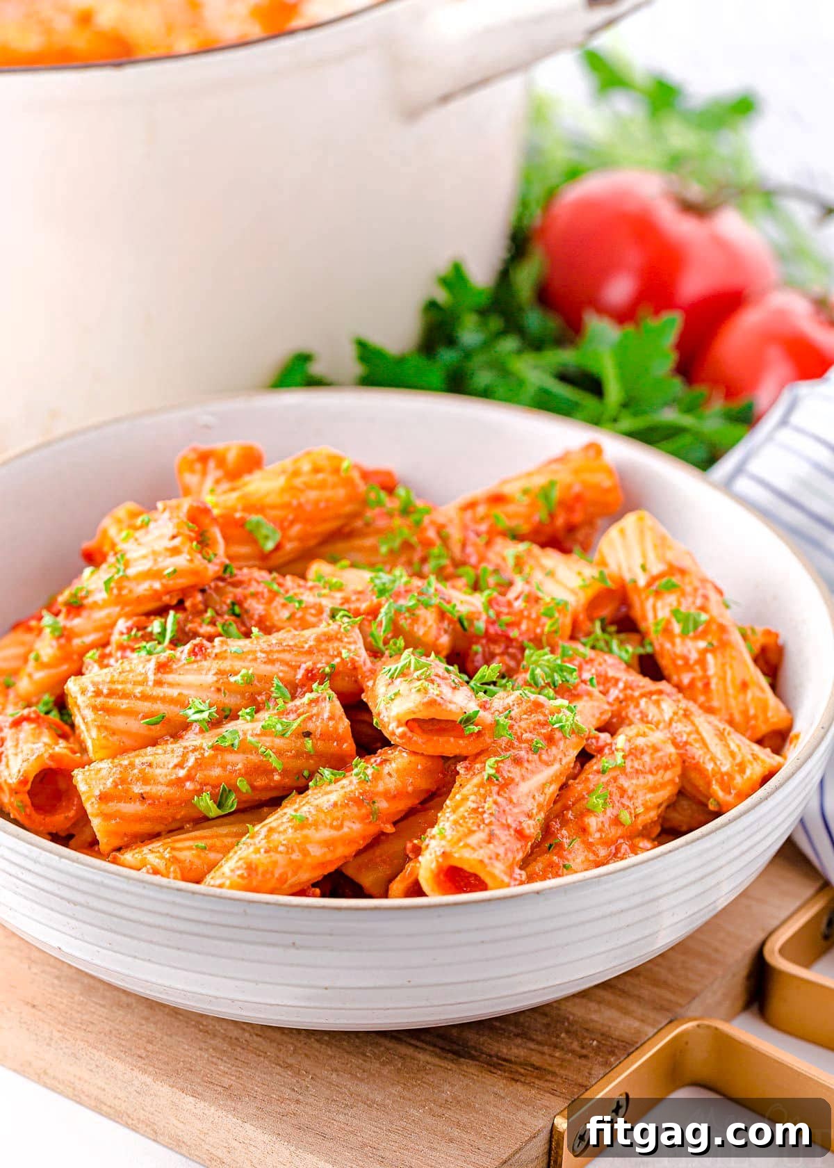 chorizo pasta in a large white pasta bowl sitting in front of large white pot.