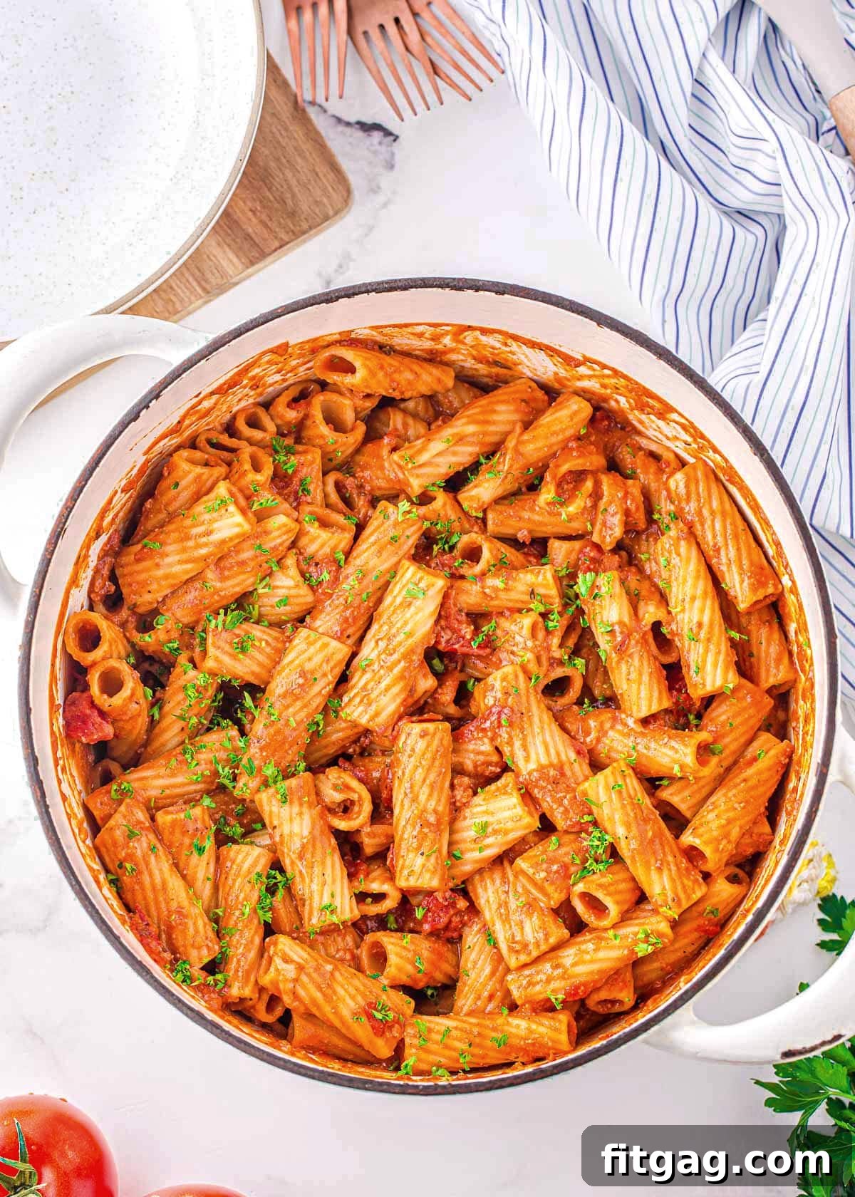 top down look at one pot pasta in a white dutch oven garnished with fresh parsley.