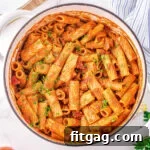 top down look at one pot pasta in a white dutch oven garnished with fresh parsley.