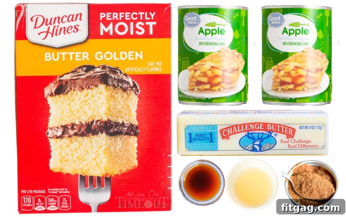 No-Fuss Apple Cobbler 5 All the essential ingredients for making an easy apple cobbler with cake mix laid out on a clean white surface, including boxes of cake mix, cans of apple pie filling, butter, lemon, vanilla extract, and a jar of apple pie spice.