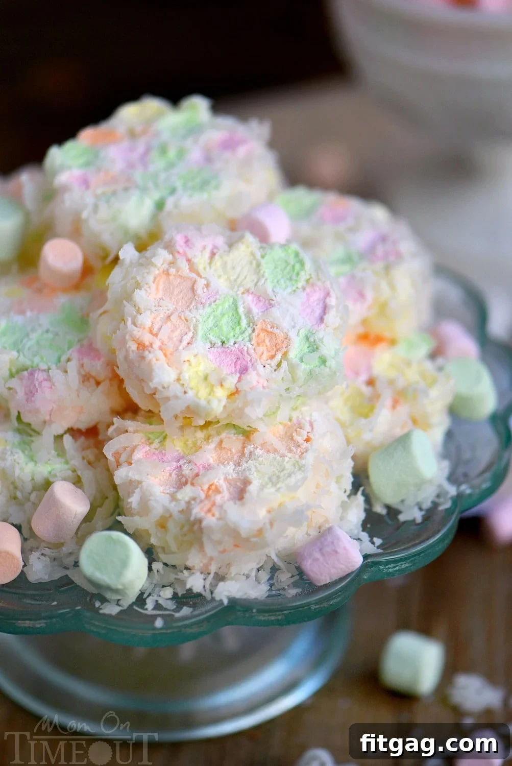 A close-up of a finished Easter Cathedral Candy log, showcasing the colorful marshmallows and coconut coating, ready to be sliced.