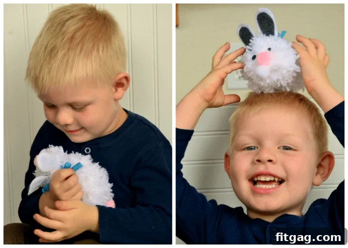 Fluffy Easter Bunny Craft 2 A young child, Bryce, happily playing with his handmade white pom pom Easter bunny, 'Comfy'.