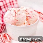 white bowl of peppermint ice cream with mini candy canes scattered about.