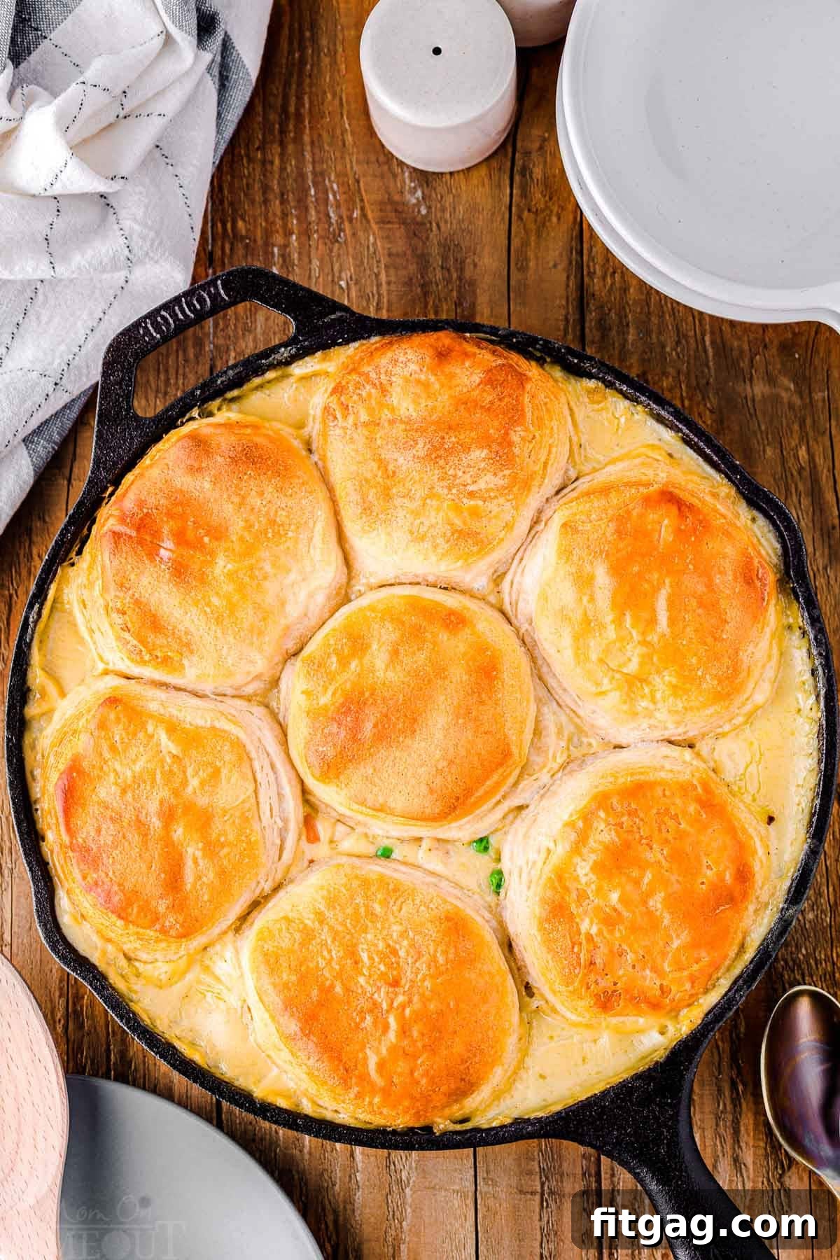 top down look at black cast iron skillet with turkey pot pie in it. skillet is sitting on a wood surface.