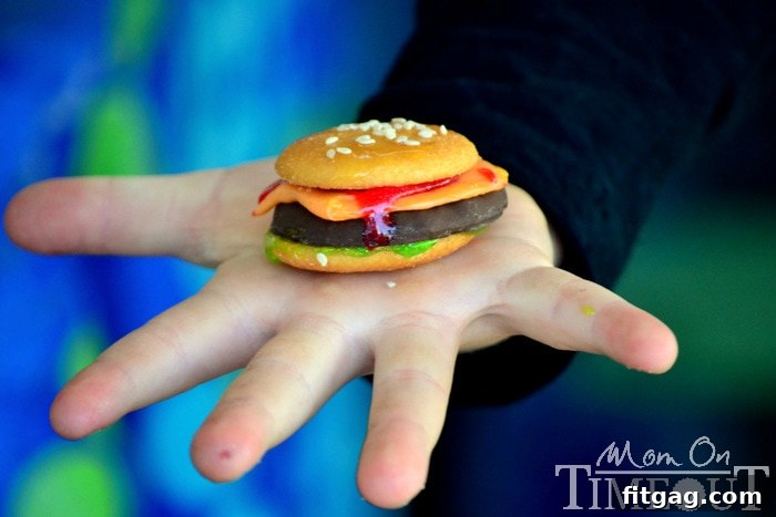 Sweet Cheeseburger Sliders 7 A child, Reece, happily holding a sweet cookie slider.