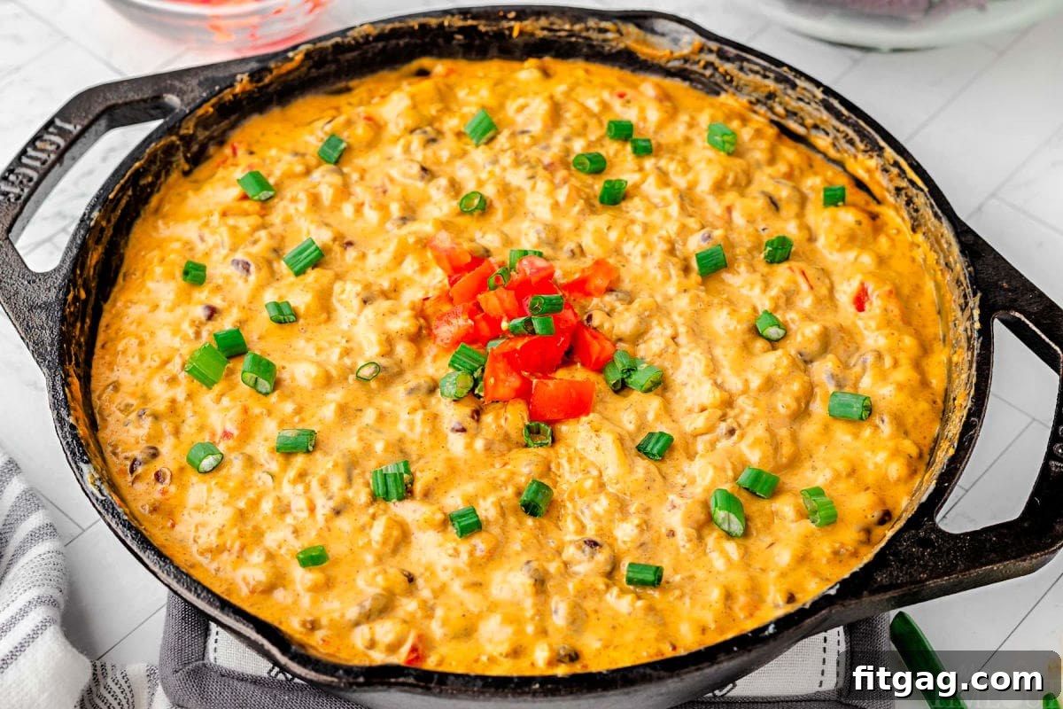 Irresistible Rotel Dip 5 rotel dip in a black cast iron skillet.