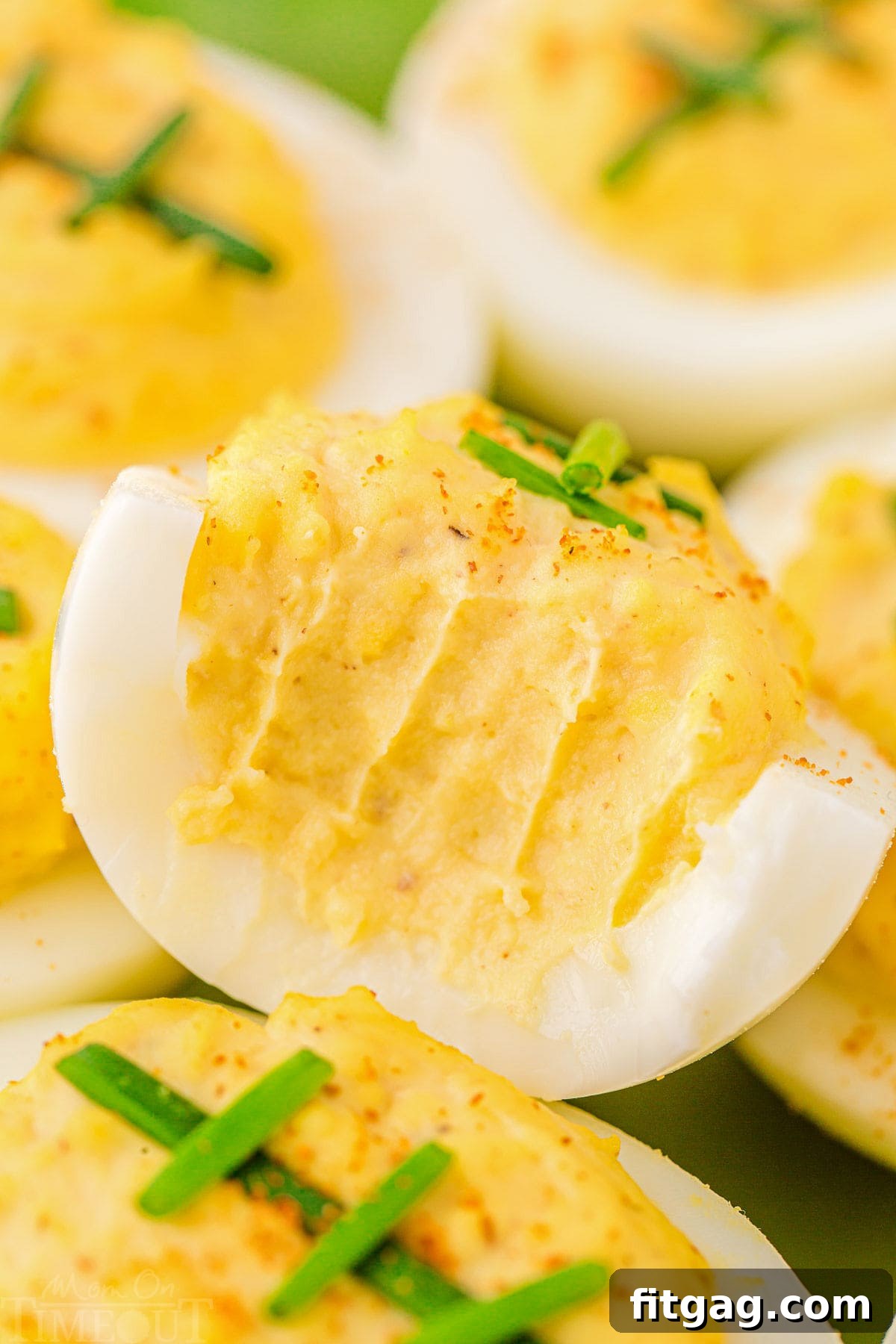 deviled eggs that are decorated to look like footballs. top deviled egg has a bite out of it.