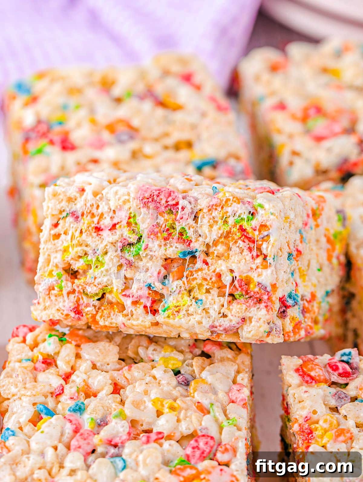 Vibrant Rainbow Krispie Bars 5 Close-up of colorful rainbow rice krispie treats cut into perfect squares and arranged beautifully, ready to be enjoyed.