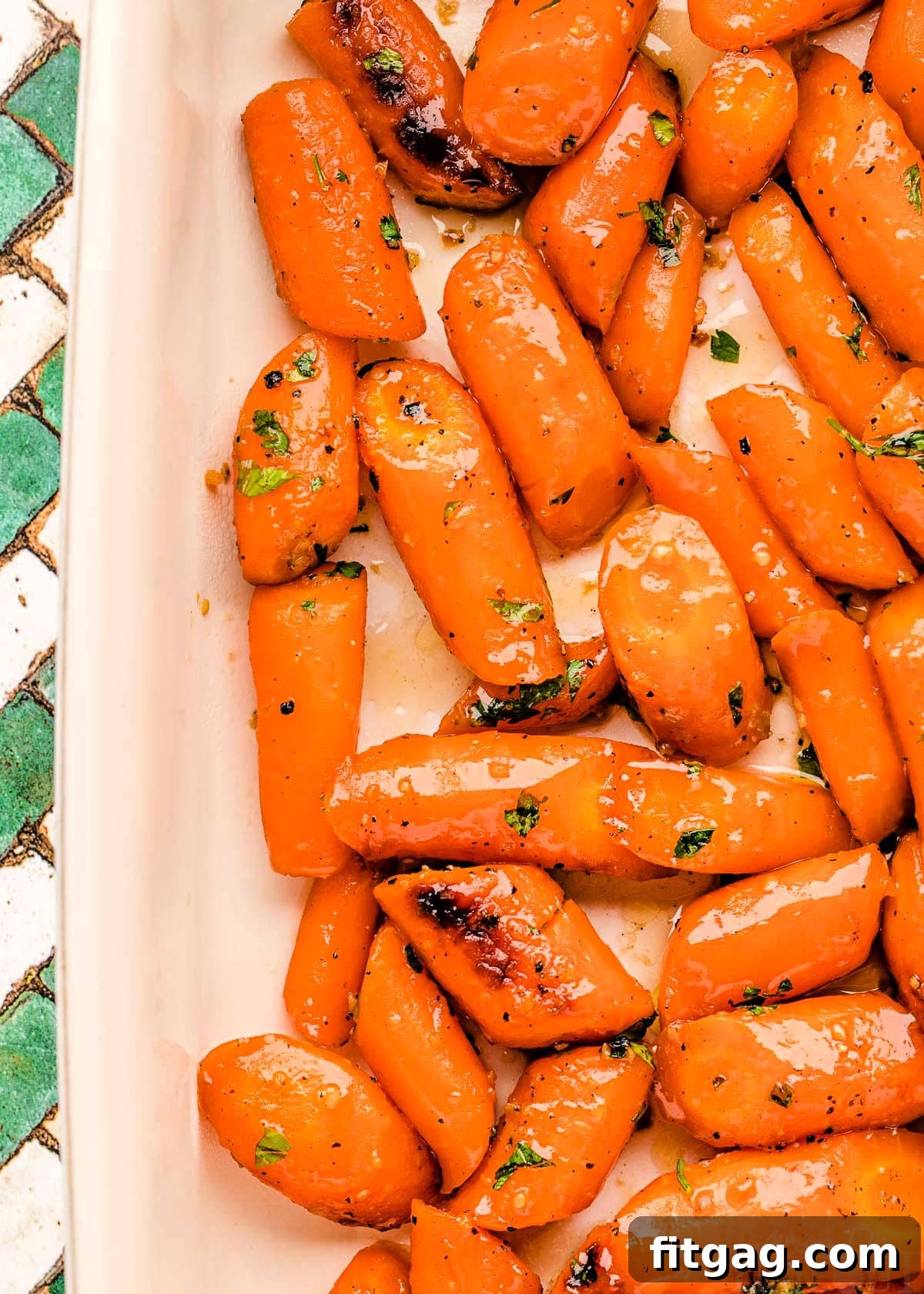 Honey Kissed Carrots 6 Top-down view of honey roasted carrots in a white baking dish.
