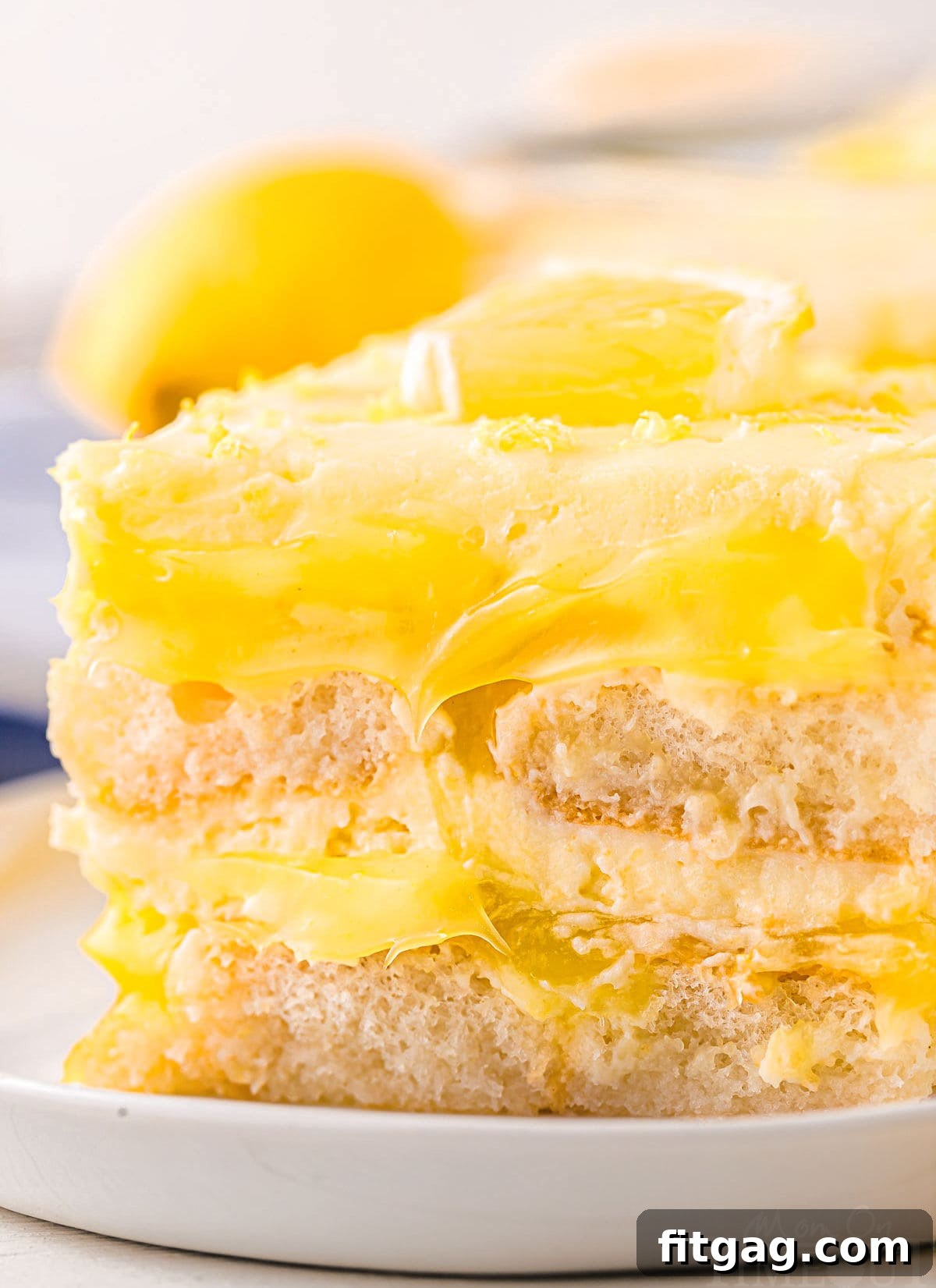 Close-up view of the intricate layers within the Lemon Tiramisu, clearly showing the light ladyfingers and vibrant lemon curd.