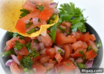 Another angle of Copycat Chipotle Pico de Gallo Salsa, showcasing its vibrant color and fresh ingredients