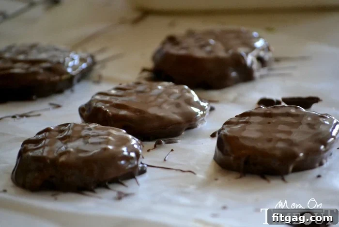Chocolate-dipped Eggo mini waffles cooling on wax paper, ready for assembly.