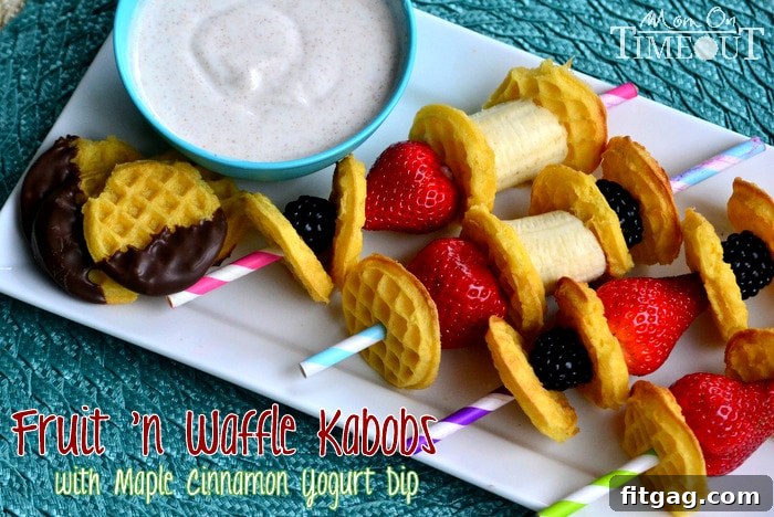 Colorful Fruit 'n Waffle Kabobs arranged artfully with a side of creamy maple cinnamon Greek yogurt dip.