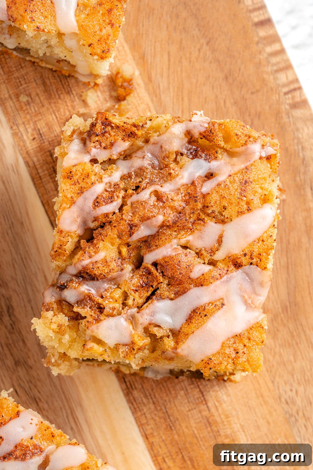 Autumn Apple Coffee Delight 7 top down view of piece of apple cinnamon coffee cake with glaze drizzled on top of it.