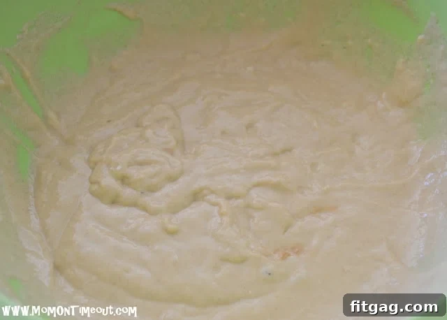Mixing dry and wet ingredients to form the fritter batter