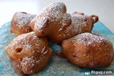 A close-up of a cherry fritter with a visible piece of cherry