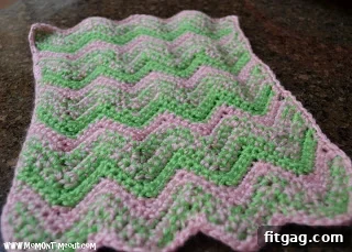 Pink and green striped crochet doll blanket