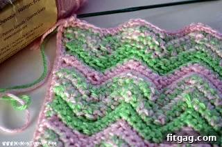Finished pink and green crochet doll blanket