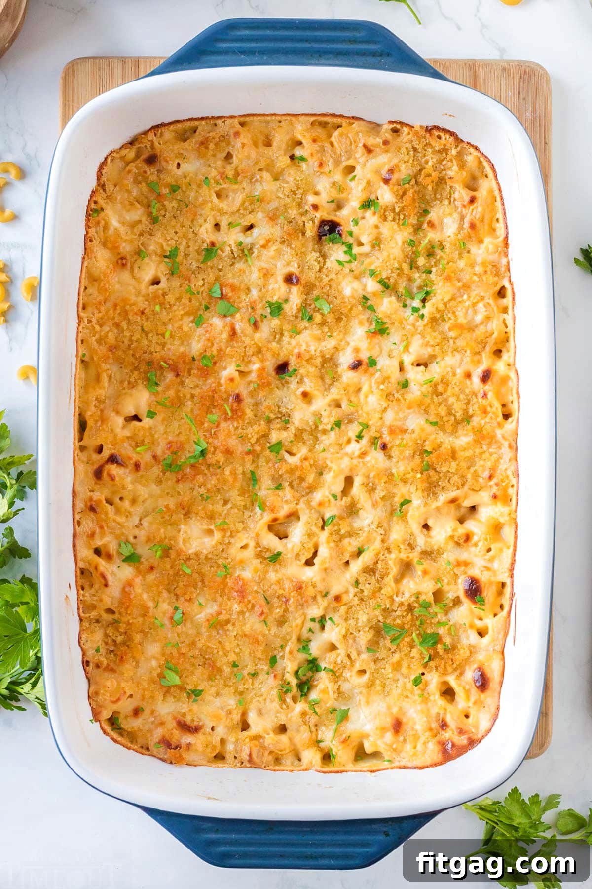 Liquid Gold Mac 3 top down look at velveeta mac and cheese in a casserole dish topped with fresh parsley.
