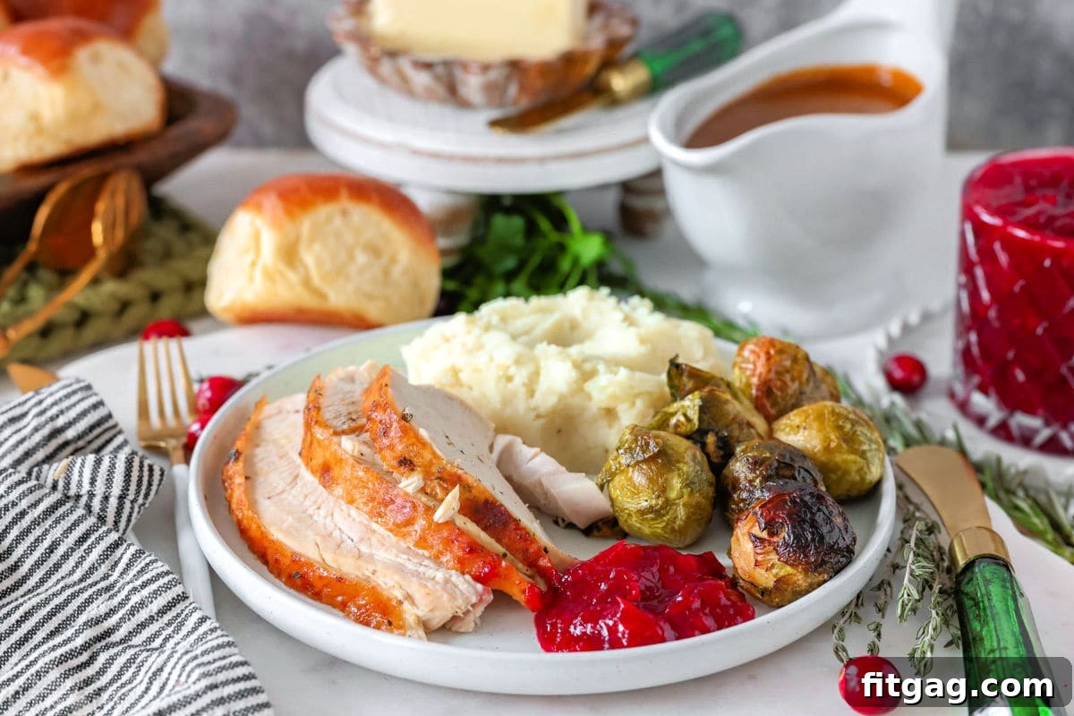 Unlock the Juiciest Thanksgiving Turkey 12 Image showing how much turkey per person on a plate with classic Thanksgiving side dishes.