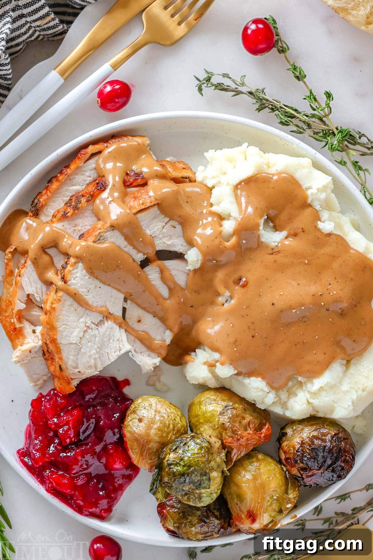 Unlock the Juiciest Thanksgiving Turkey 3 Top down look at thanksgiving turkey plated with various sides and topped with turkey gravy.