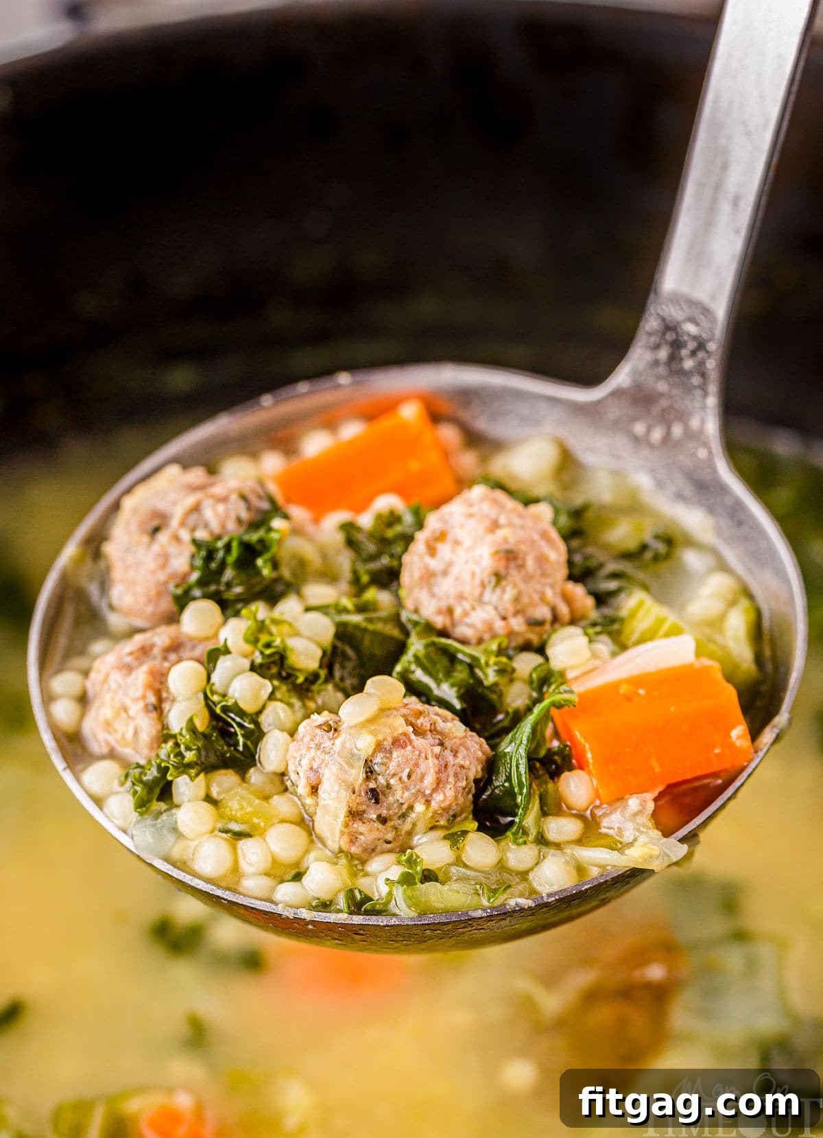 Italian Union Soup 3 ladle full of italian wedding soup in a dutch oven filled with more soup.