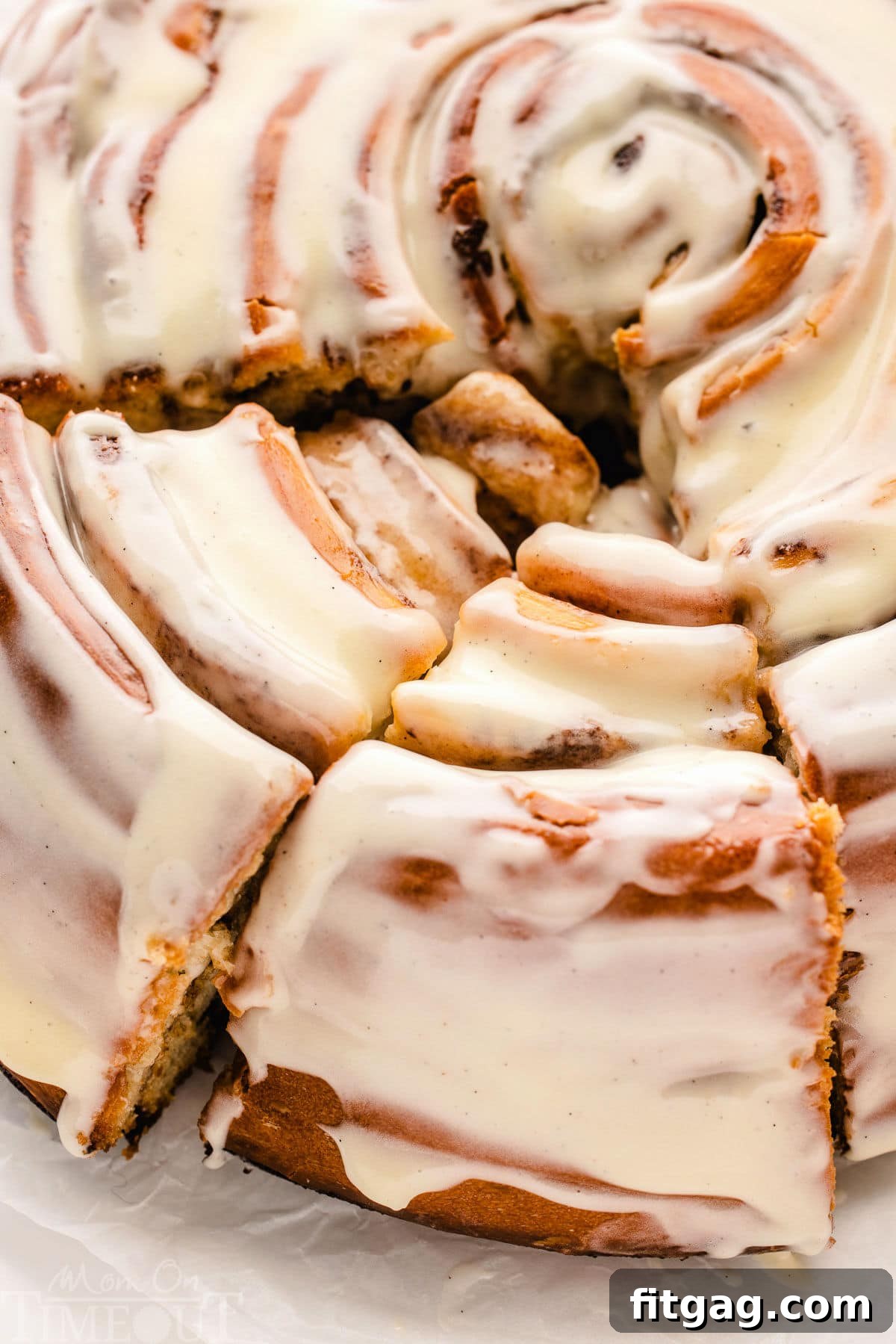 Colossal Cinnamon Swirl Cake 2 close up, top down look at giant cinnamon roll cake recipe with two slices cut.