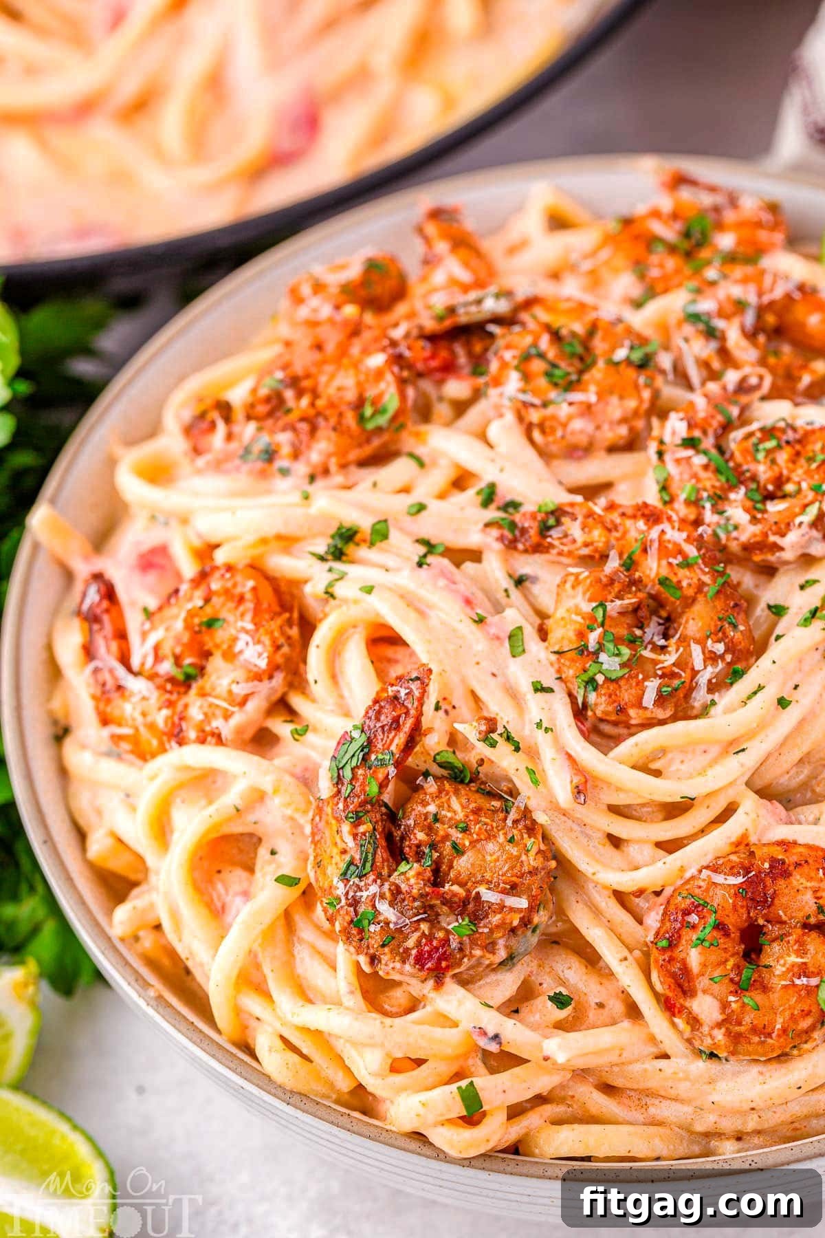 An enticing close-up of a bowl of creamy Cajun Shrimp Pasta, featuring a rich Parmesan cream sauce, spicy shrimp, and a garnish of fresh parsley.