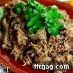 Slow Cooker Carnitas in a bowl with cilantro