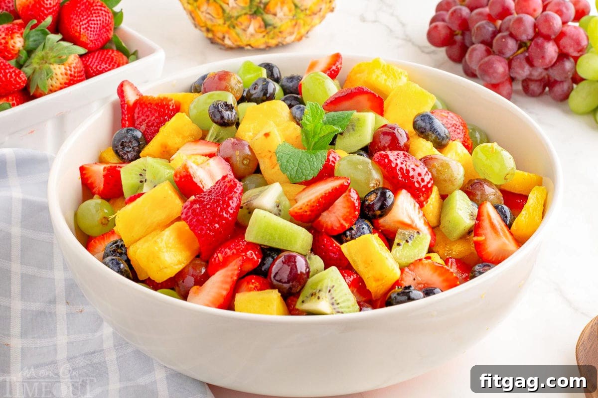 Sunshine Fruit Medley 7 A white serving bowl filled with a delightful mix of strawberries, pineapple, blueberries, kiwis, and grapes for an easy fruit salad.